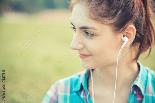 beautiful young hipster woman listening music