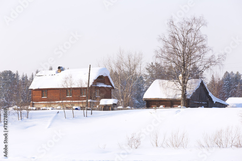Wooden houses in the village in the winter © Aleksei Lazukov