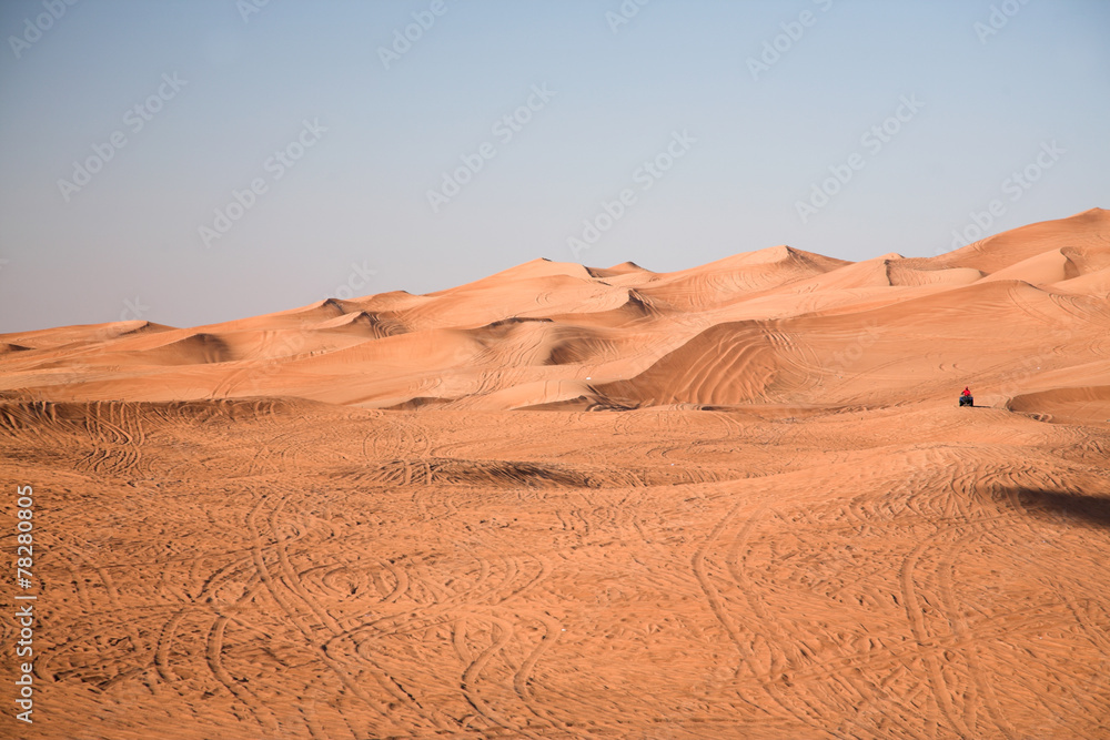 Desert dunes, an off-road vehicle alone