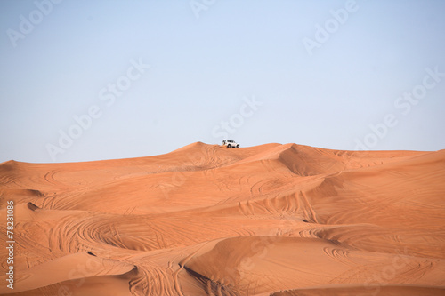 Desert dunes, an off-road car alone