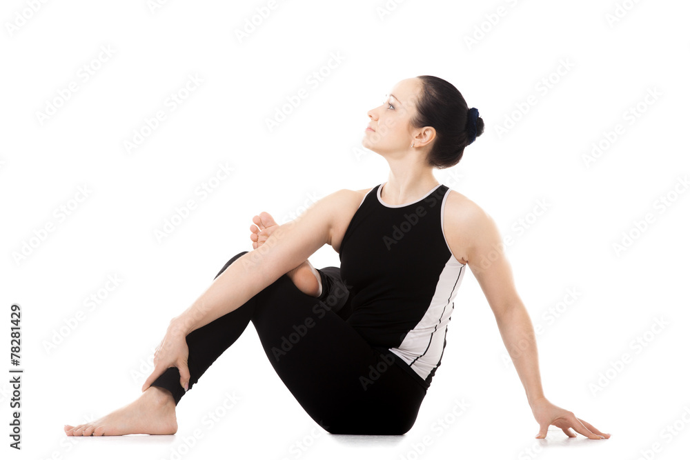 Yogi athlete girl in yoga asana parivritta Eka Pada Agnistambhas Yogi athlete girl in yoga asana parivritta Eka Pada Agnistambhas
