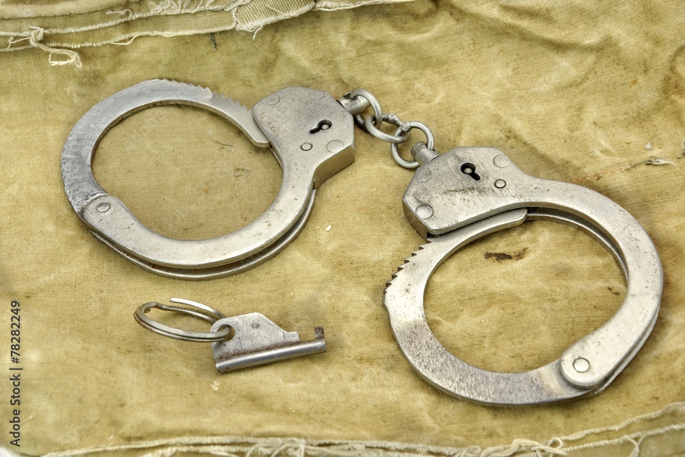 Handcuffs with Key On The Camouflage Army Bag or Fabric Handcuffs with Key On The Camouflage Army Bag or Fabric