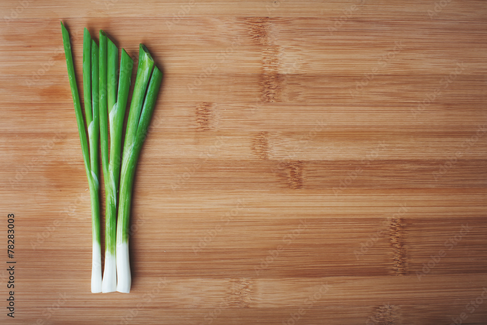 green onions on a wooden background green onions on a wooden background