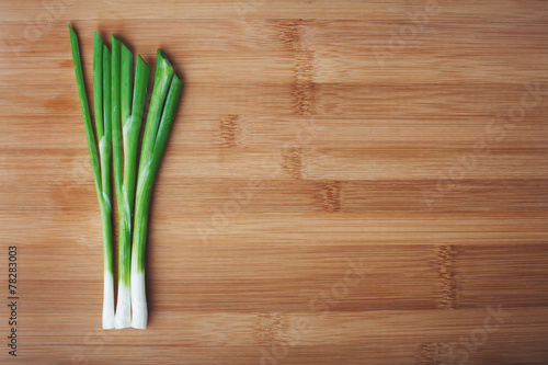 green onions on a wooden background