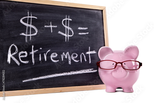 Piggy Bank or piggybank with retirement pension savings growth formula calculation written on small blackboard isolated on white background photo