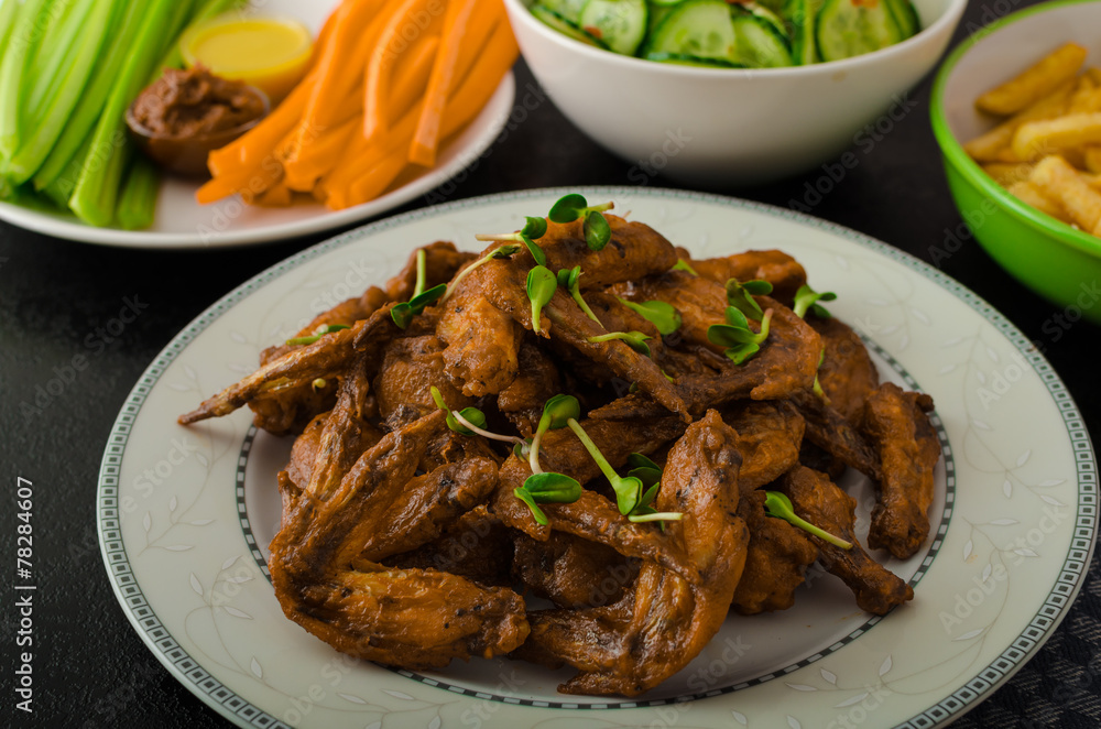 Sports feast - chicken wings, vegetable, french fries, pizza