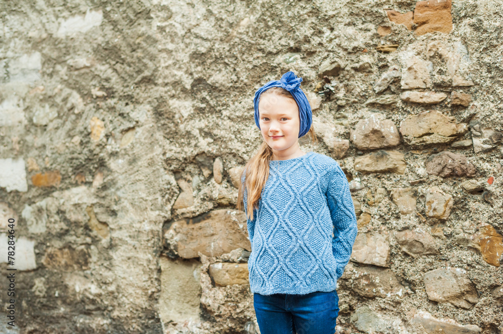 Outdoor portrait of a cute fashion little girl