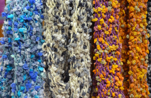 Colorful knitted scarves on display