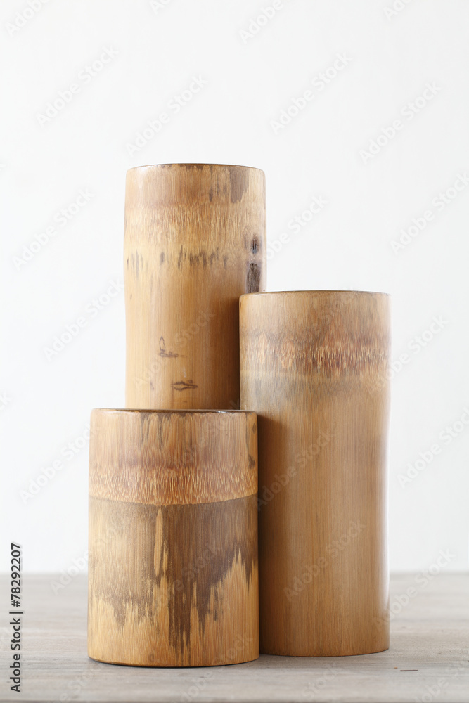 Triple dry bamboo segment oon wooden table Triple dry bamboo segment oon wooden table