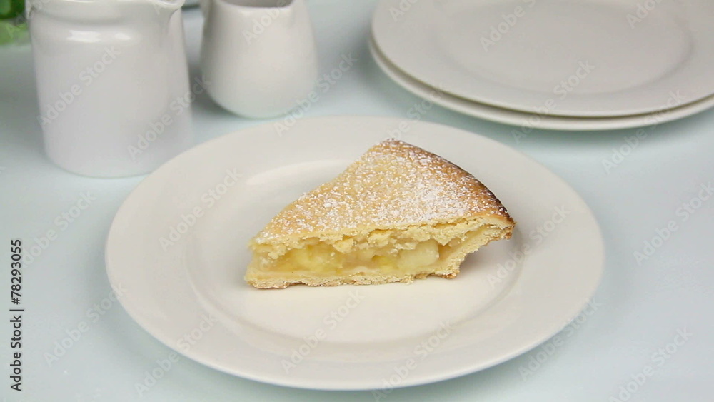 Slice of apple pie with cream poured over it. Slice of apple pie with cream poured over it.