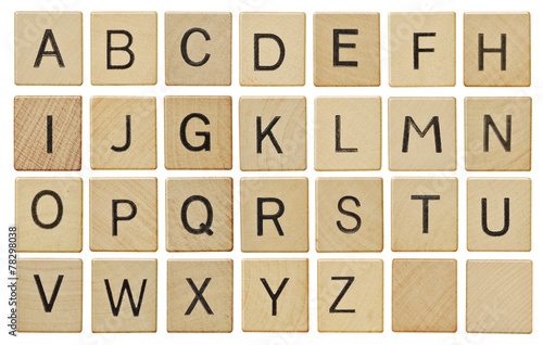 Fotótapéta Alphabet letters on wooden scrabble pieces, isolated on white.