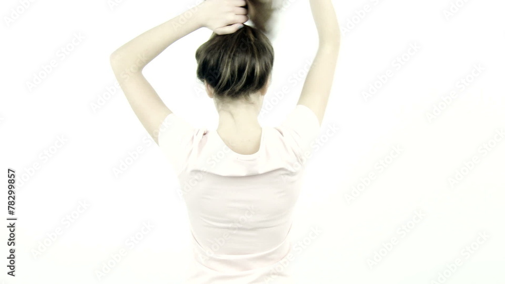 Female teenager undoing bun moving long healthy hair Female teenager undoing bun moving long healthy hair