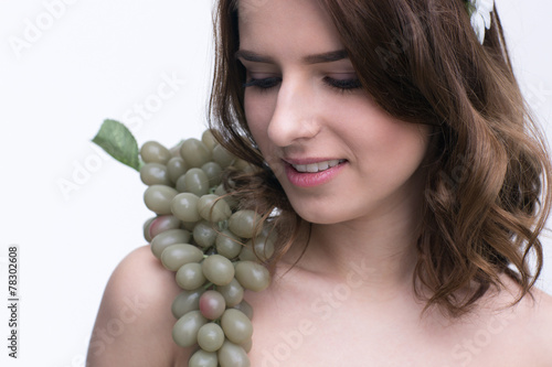 Smiling cute woman with bunch of grapesand photo