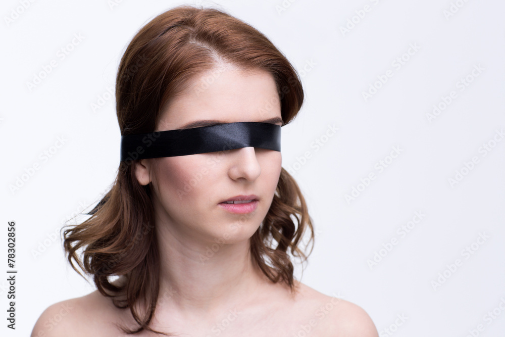 Blindfold beautiful woman over gray background Blindfold beautiful woman over gray background