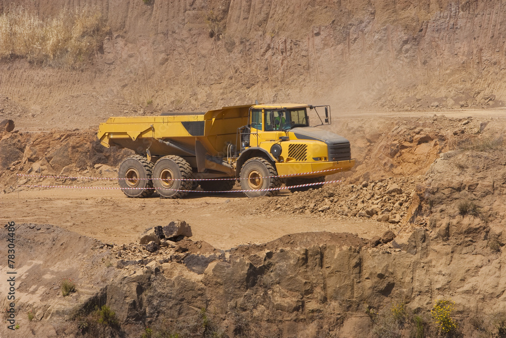 Fototapeta premium Truck and bulldozer work in the quarry
