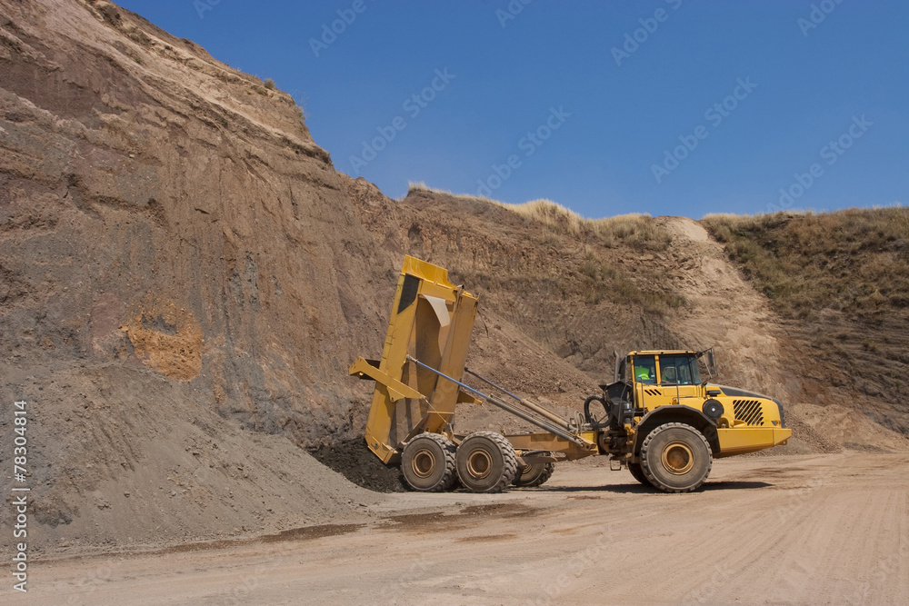 Truck and bulldozer work in the quarry Truck and bulldozer work in the quarry