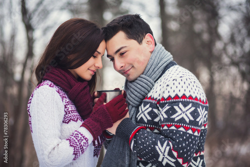 romantic couple drinking coffee in the winter park © jozzeppe777