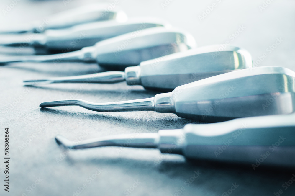Dentist chisels tools arranged on table by size Dentist chisels tools arranged on table by size