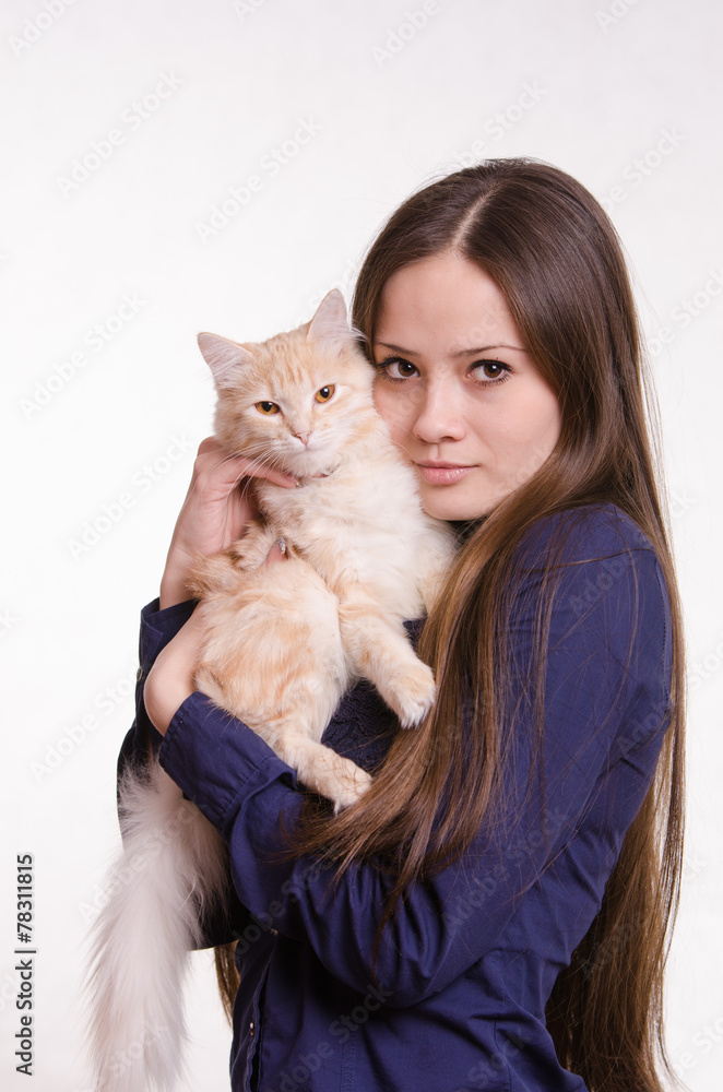The girl is holding a red cat The girl is holding a red cat