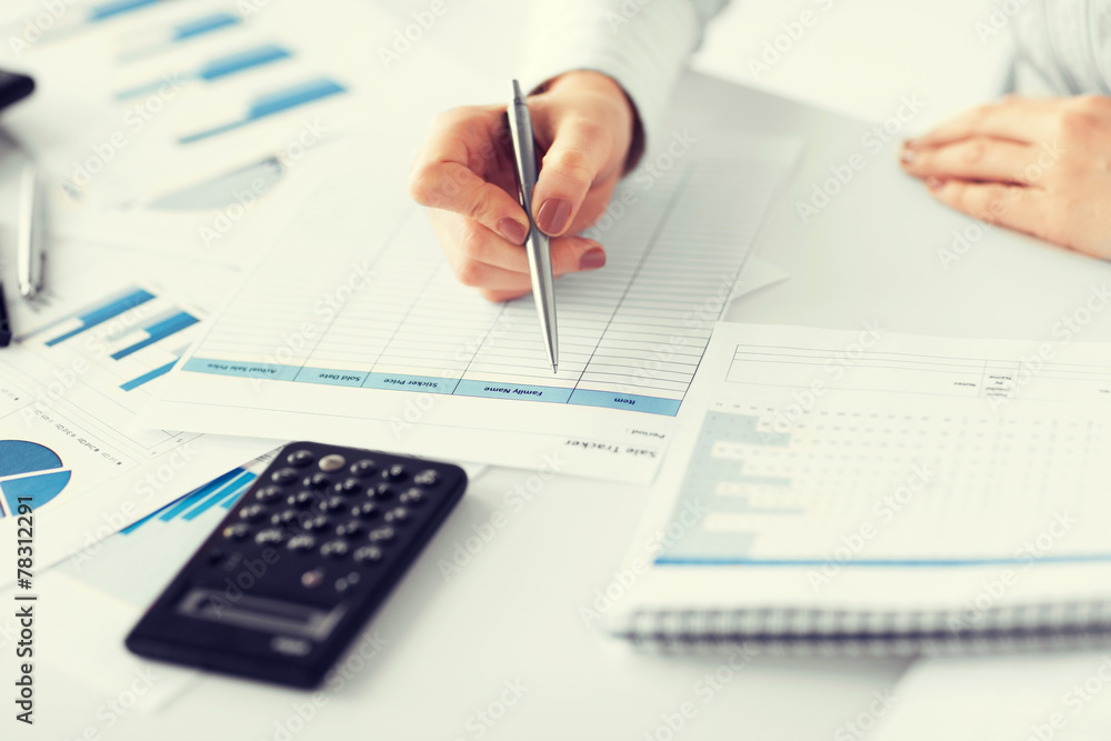 woman hand with calculator and papers woman hand with calculator and papers