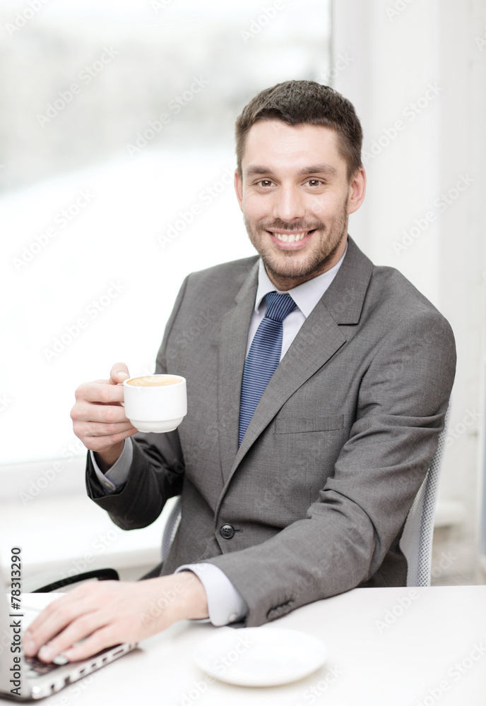 smiling businessman with laptop and coffee smiling businessman with laptop and coffee