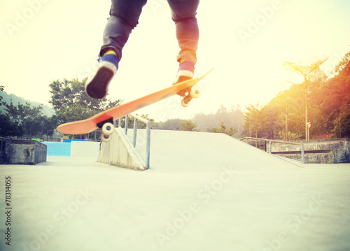 skateboarding legs jumping at skatepark