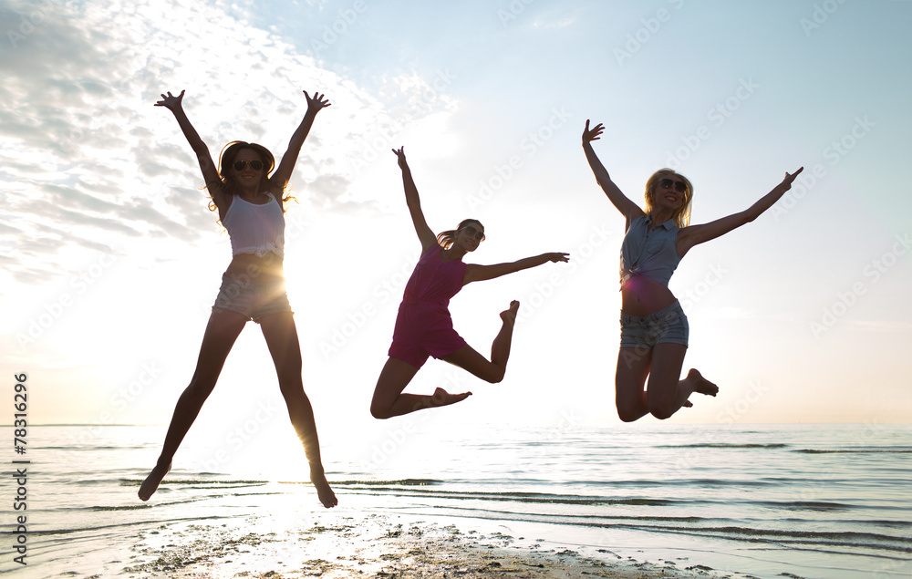 happy female friends dancing and jumping on beach happy female friends dancing and jumping on beach