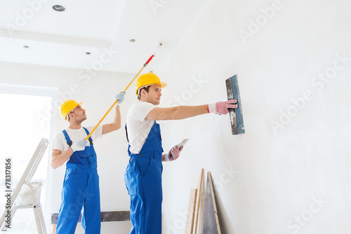 group of builders with tools indoors photo