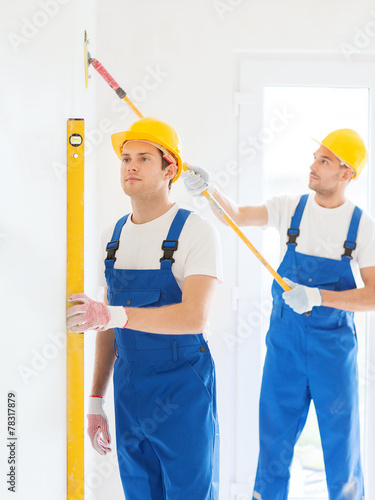 group of builders with tools indoors