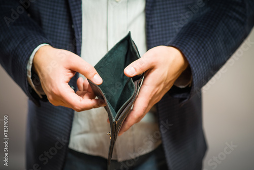Bankruptcy - Business Person holding an empty wallet photo