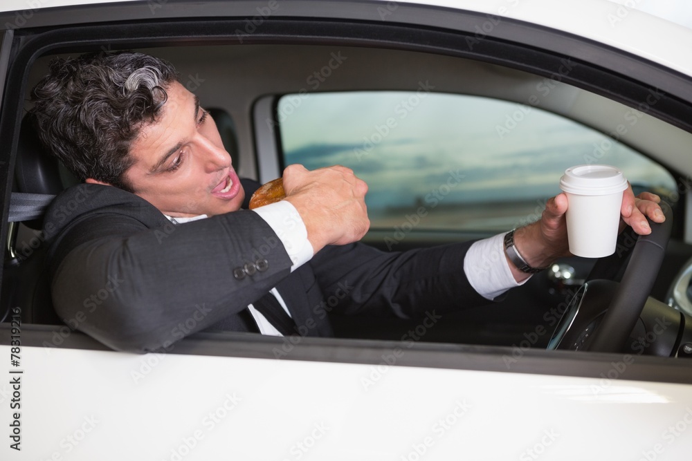 Man drinking coffee and eating donnut on phone Man drinking coffee and eating donnut on phone