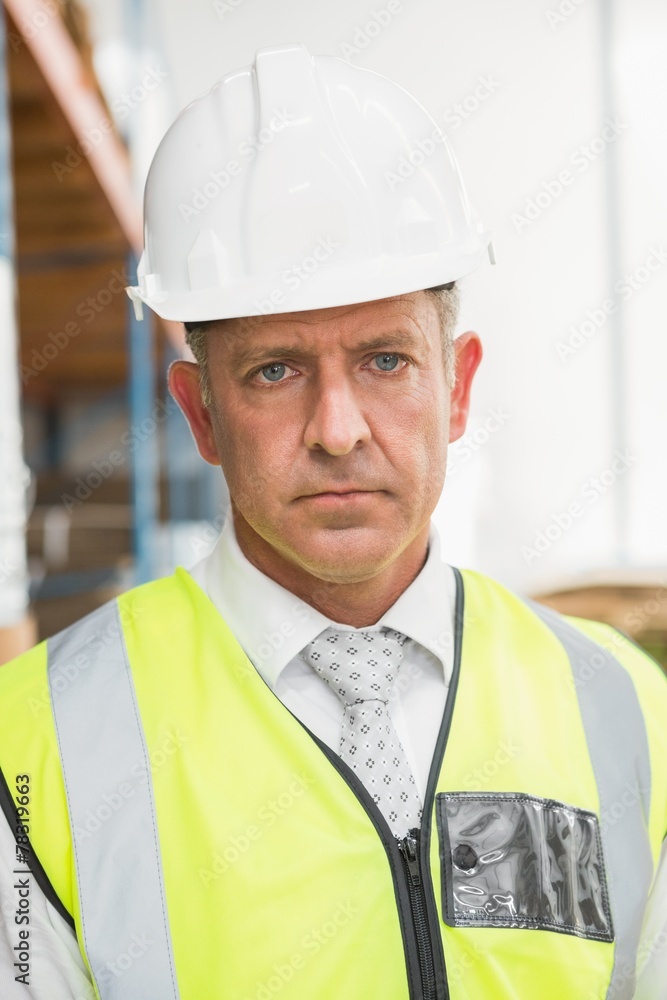 Manager wearing hard hat in warehouse Manager wearing hard hat in warehouse