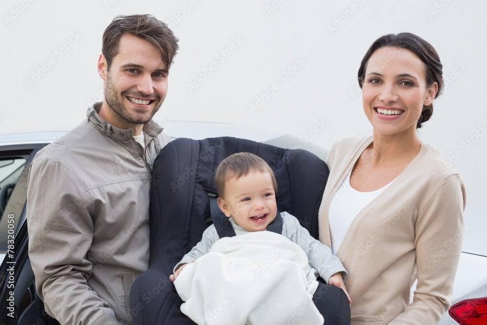 Parents carrying baby in his car seat Parents carrying baby in his car seat