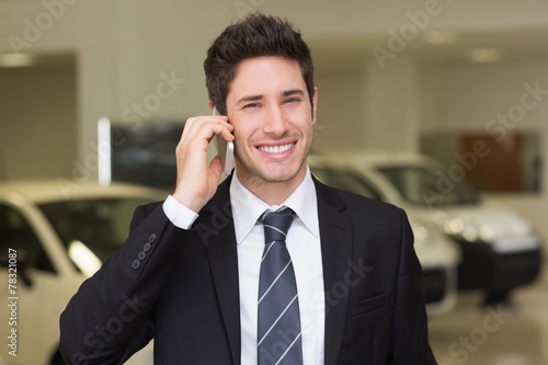 Smiling businessman calling with his mobile phone