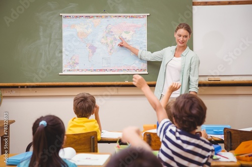 Slika na platnu Teacher giving a geography lesson in classroom