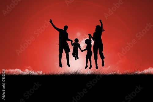 Silhouette of family jumping