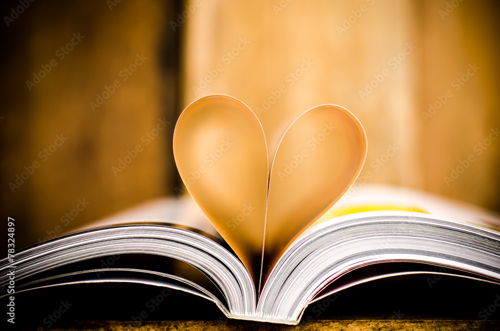 Heart from book pages on wood background Heart from book pages on wood background