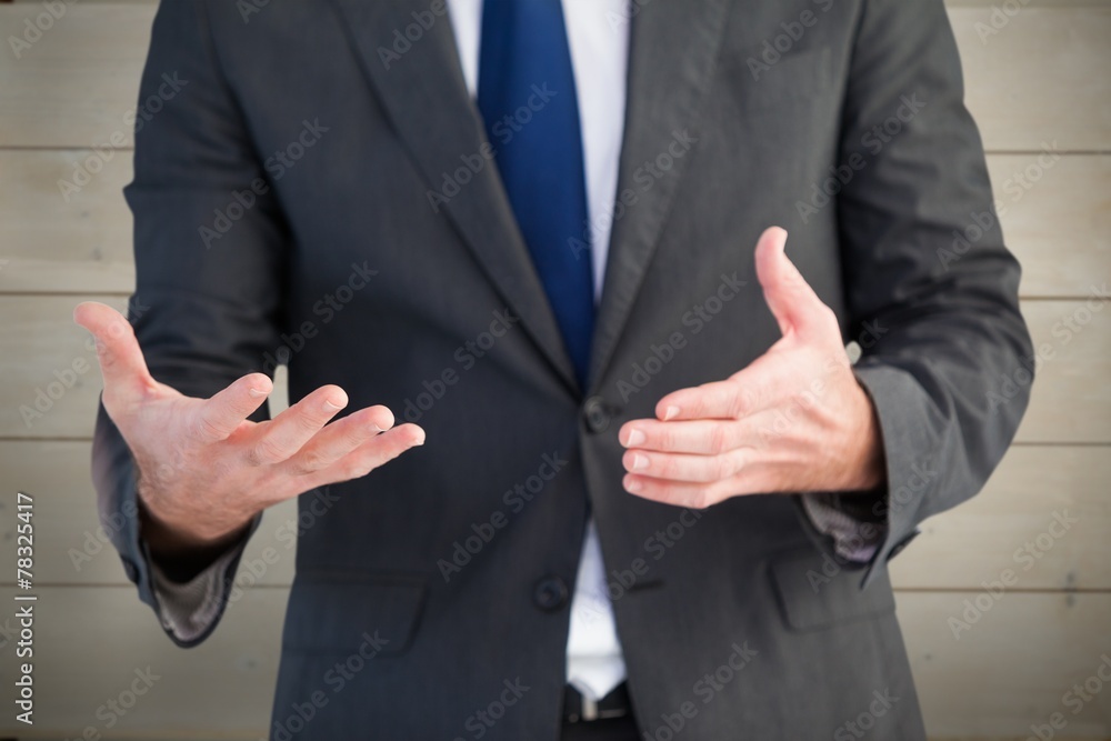 Composite image of handsome businessman presenting with hands
