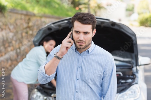 Young couple after a car breakdown