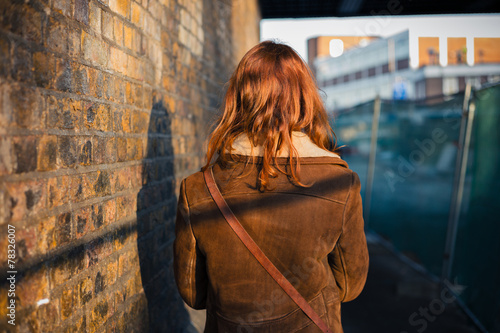 Woman walking in a city in the winter © LoloStock