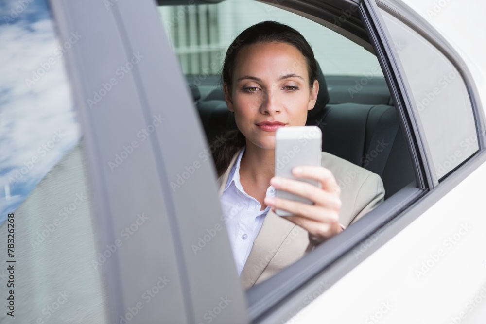Focused businesswoman using her phone Focused businesswoman using her phone
