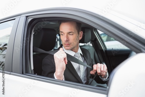 Businessman putting on his seat belt © WavebreakmediaMicro