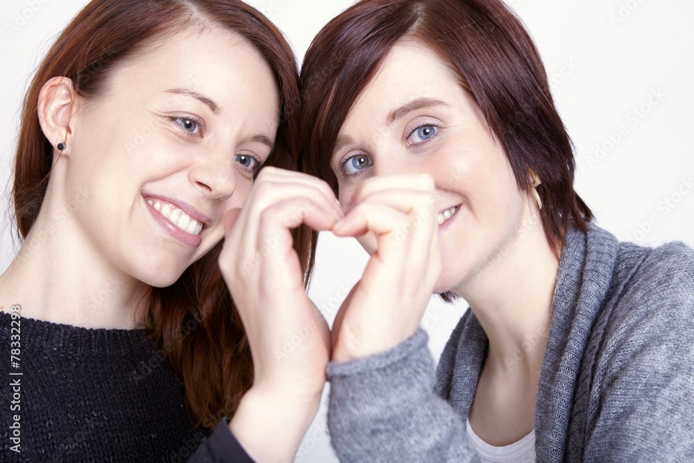 two girls friends make a heart with hands two girls friends make a heart with hands