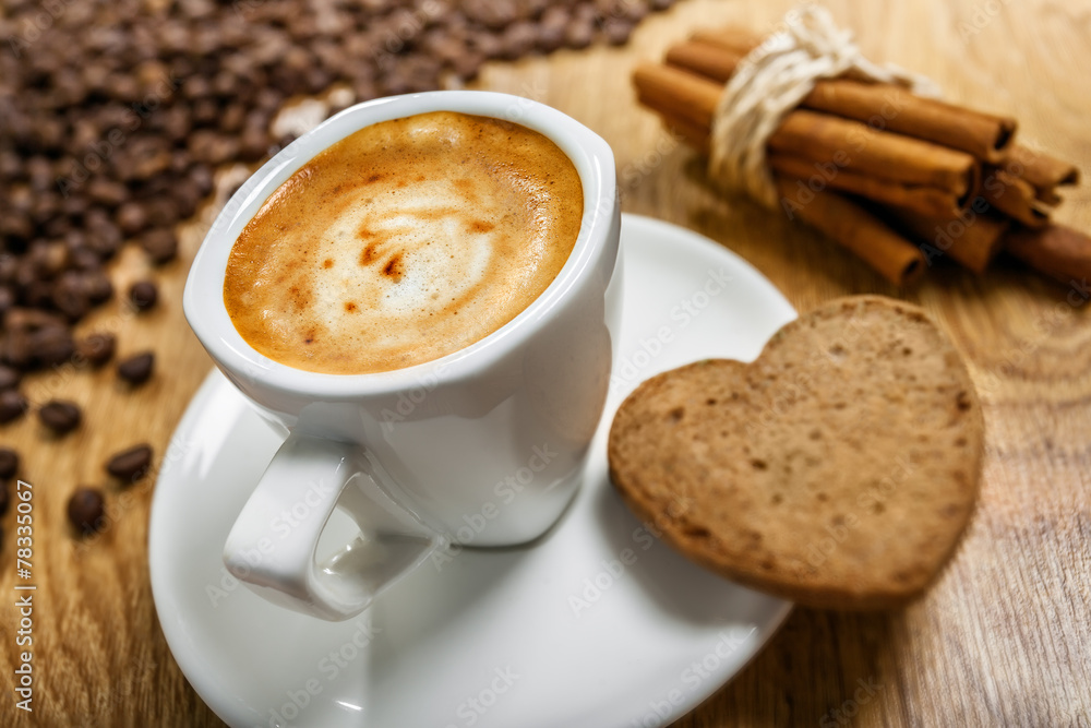 Cup of coffee with cookie heart and cinnamon Cup of coffee with cookie heart and cinnamon