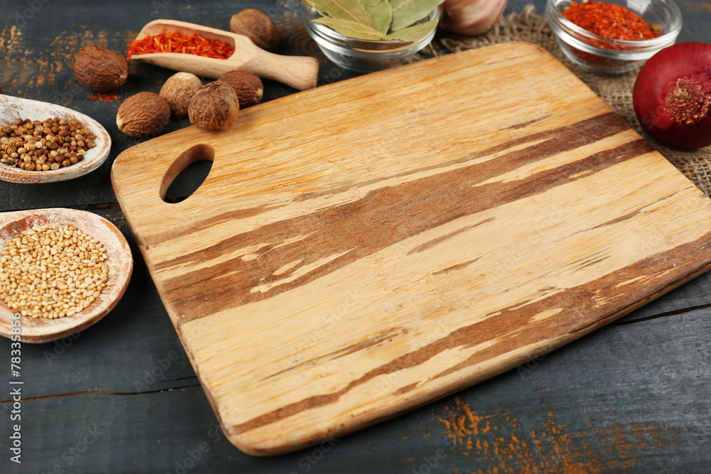 Different spices and herbs with cutting board Different spices and herbs with cutting board