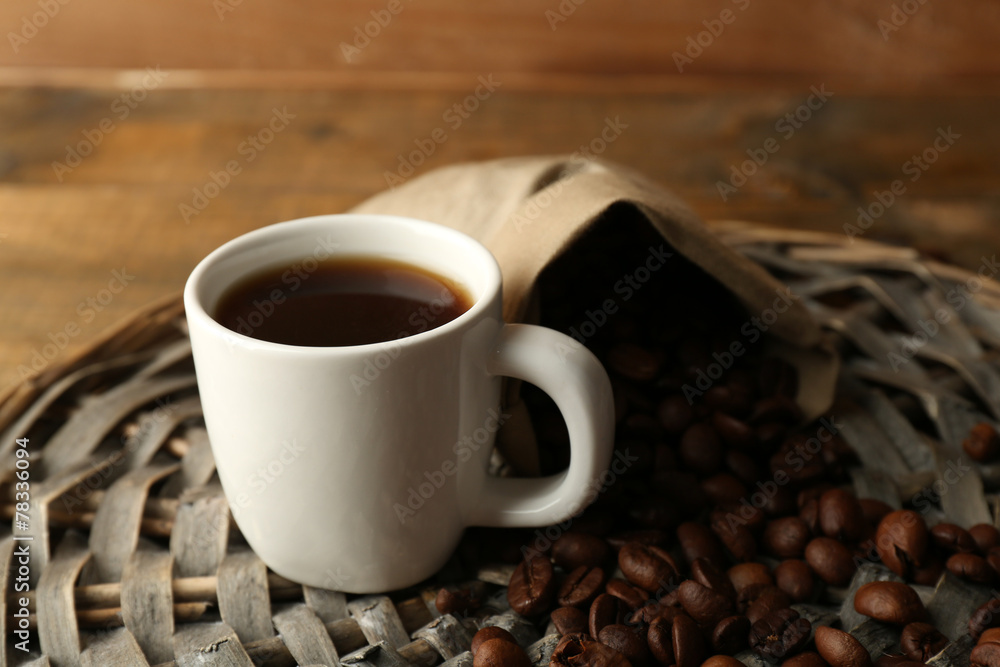 Cup of coffee with beans on rustic wooden background Cup of coffee with beans on rustic wooden background