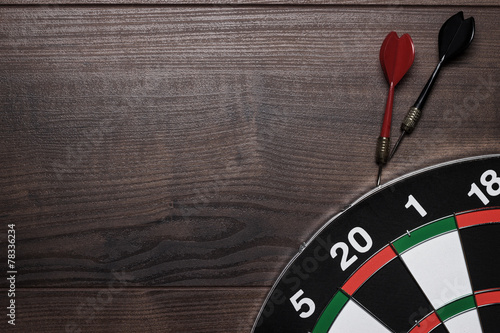 Принти на полотні target and two darts over brown wooden table background