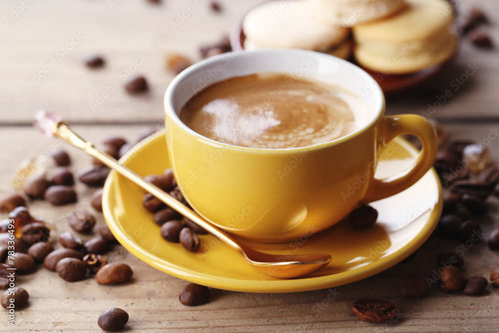 Gentle colorful macaroons and coffee in mug Gentle colorful macaroons and coffee in mug