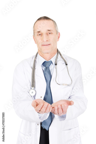 Mature male doctor with open hands