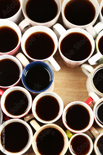 Many cups of coffee on wooden table background  closeup view